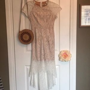 Fabulous lace dress. Short at front a d long at back. Light beige flesh lining.